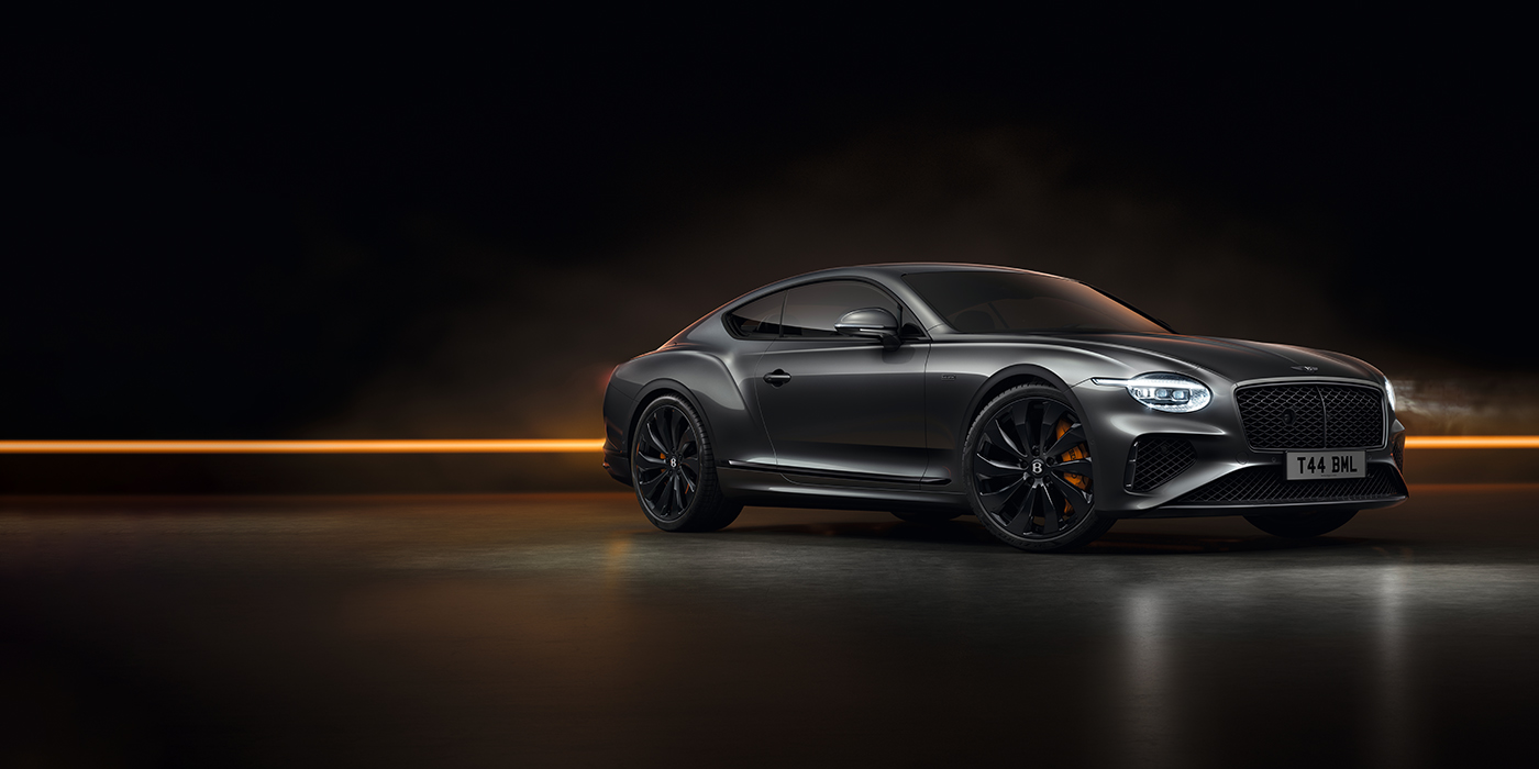 Thomas Exclusive Cars GmbH Bentley Continental GT Black Edition coupe front three quarter in Anthracite black paint against a dark grey and copper background