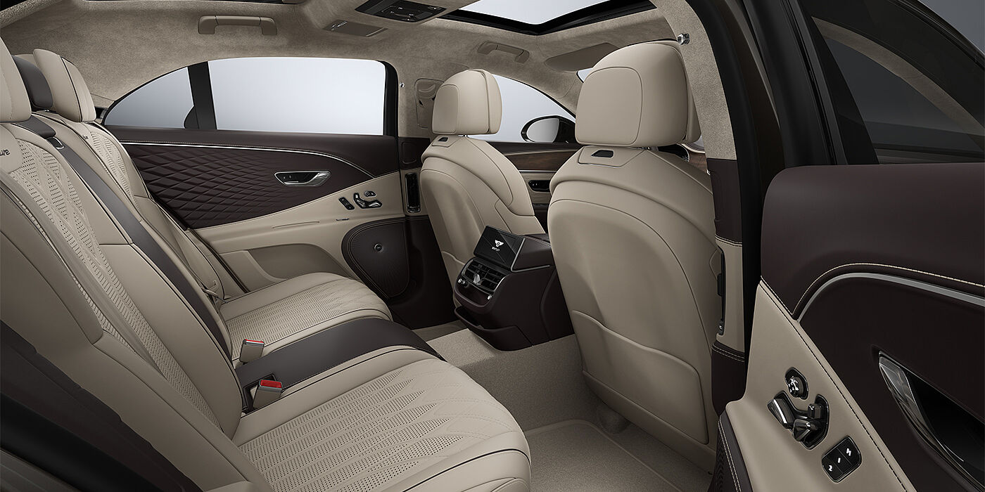 Thomas Exclusive Cars GmbH New Bentley Flying Spur Azure sedan rear interior in Portland and Burnt Oak hides with Open Pore Crown Cut Walnut veneer