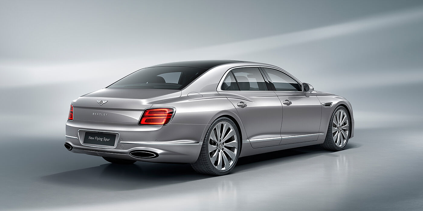 Thomas Exclusive Cars GmbH New Bentley Flying Spur sedan rear view in Silverlake paint with ten spoke wheels and chrome matrix grille