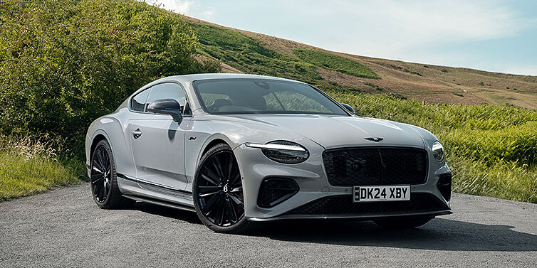 Thomas Exclusive Cars GmbH Bentley Continental GT front three quarter with Carbon Fibre Specification parked on road.