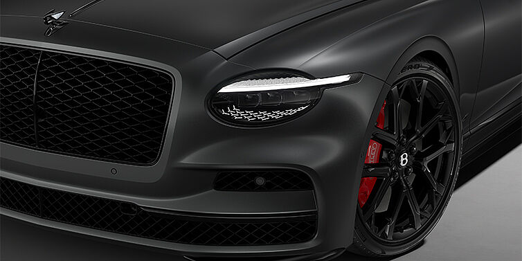 Thomas Exclusive Cars GmbH New Bentley Flying Spur S sedan head lamp against Anthracite Satin paint with  22" Sports wheel
