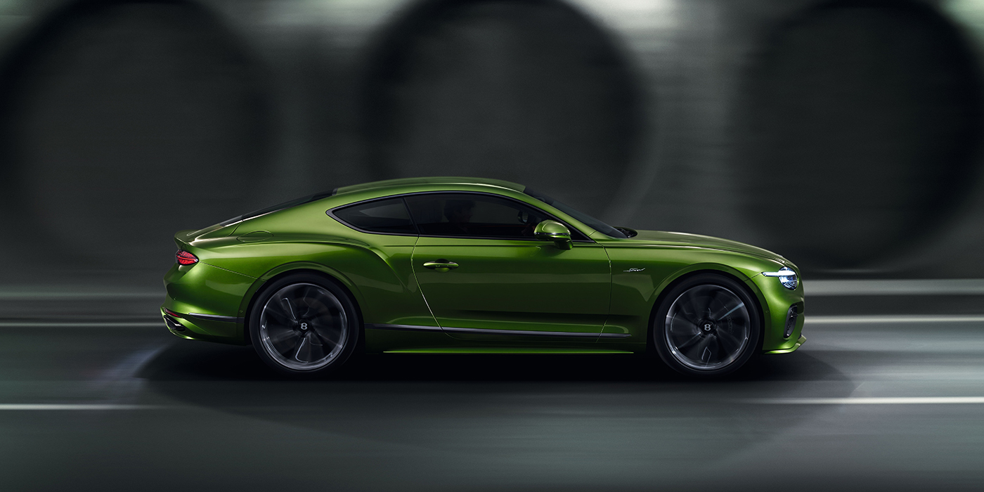 Thomas Exclusive Cars GmbH Bentley Continental GT coupe in Tourmaline Green paint driving in profile on a dark road
