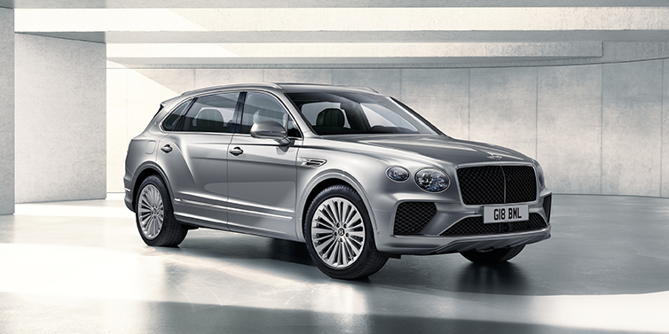 Thomas Exclusive Cars GmbH Bentley Bentayga Extended Wheelbase SUV front three quarter in Moonbeam paint with a grey background