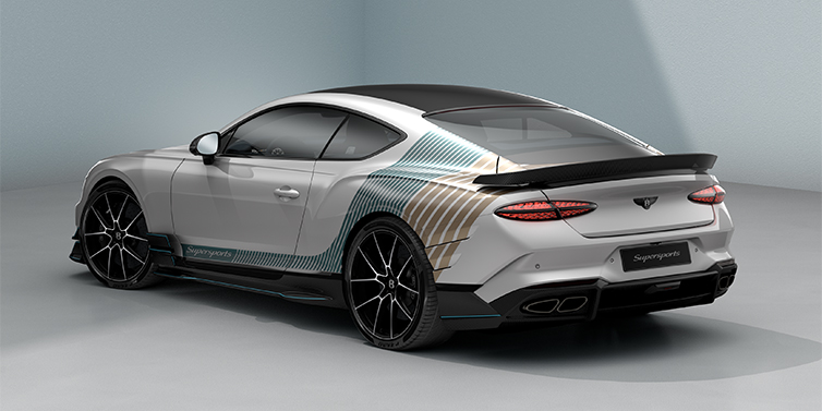 Thomas Exclusive Cars GmbH Bentley Supersports rear three quarter in "Snowstorm" Design theme with Snow Quartz paint and Topaz blue and Camel brown paint stripes across the rear haunch.