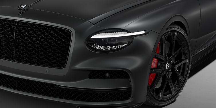 Thomas Exclusive Cars GmbH New Bentley Flying Spur S sedan head lamp against Anthracite Satin paint with  22" Sports wheel