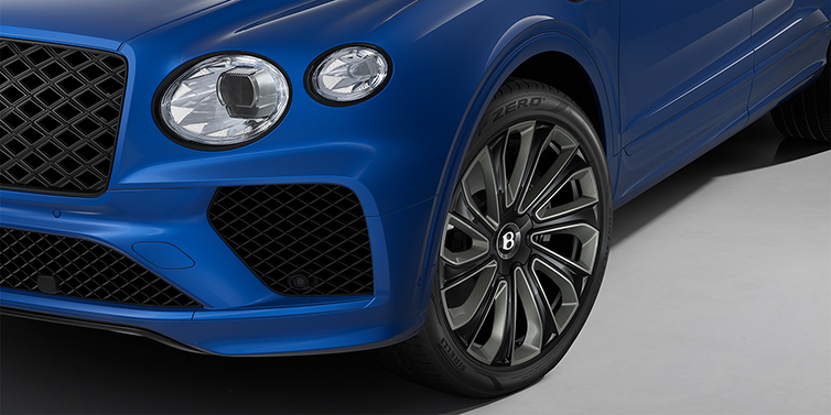 Thomas Exclusive Cars GmbH Bentley Bentayga Artenara Edition SUV front detail in Sequin Blue paint and 22" Mulliner Gloss Black wheels front 3/4