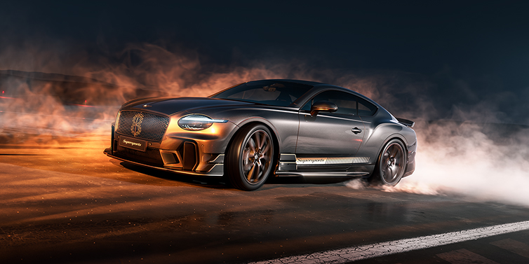 Thomas Exclusive Cars GmbH Bentley Supersports front three quarter in "Nightfall" Design theme with Anthracite paint, Camel accents and Camel and Beluga black striping standing on mist covered concrete