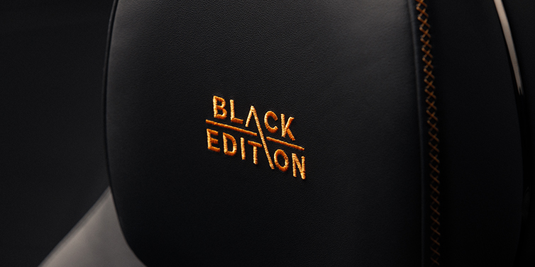 Thomas Exclusive Cars GmbH Bentley Continental GT coupe seat headrest Black Edition stitched emblem in Mandarin colour against Beluga black hide