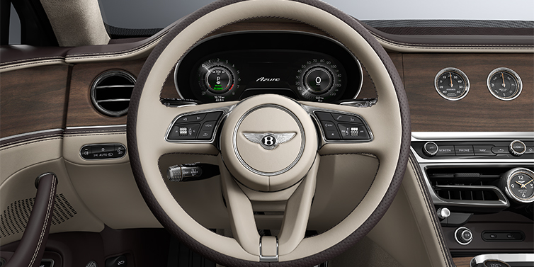 Thomas Exclusive Cars GmbH New Bentley Flying Spur Azure sedan steering wheel and dash in Portland and Burnt Oak hides and Open Pore Crown Cut Walnut veneer